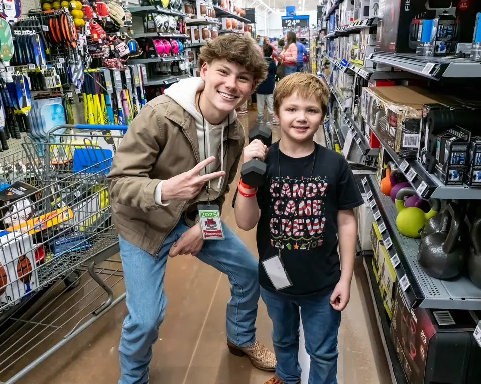 Two boys throwing up peace signs in the aisle